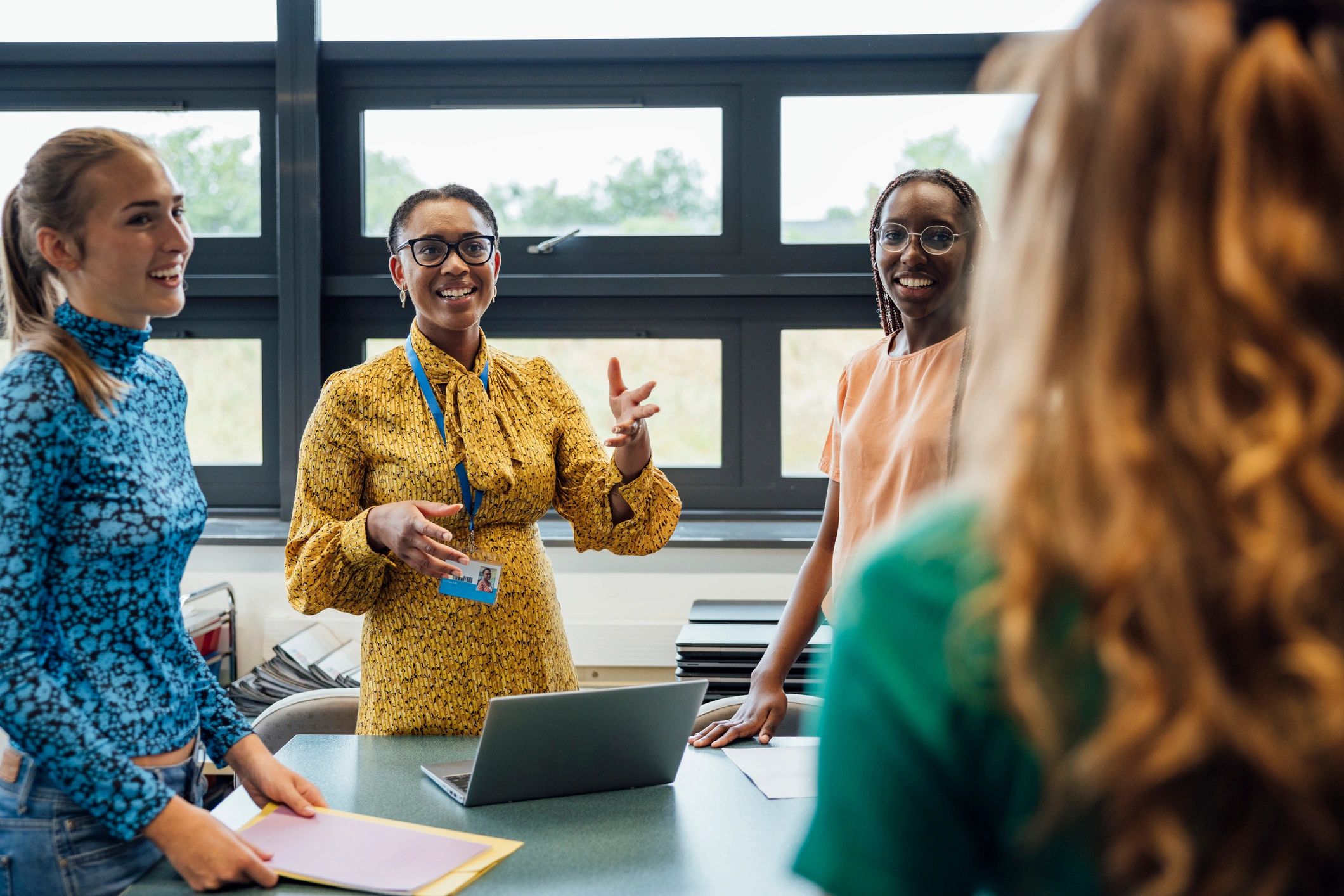 Teacher speaking with students in a modern classroom