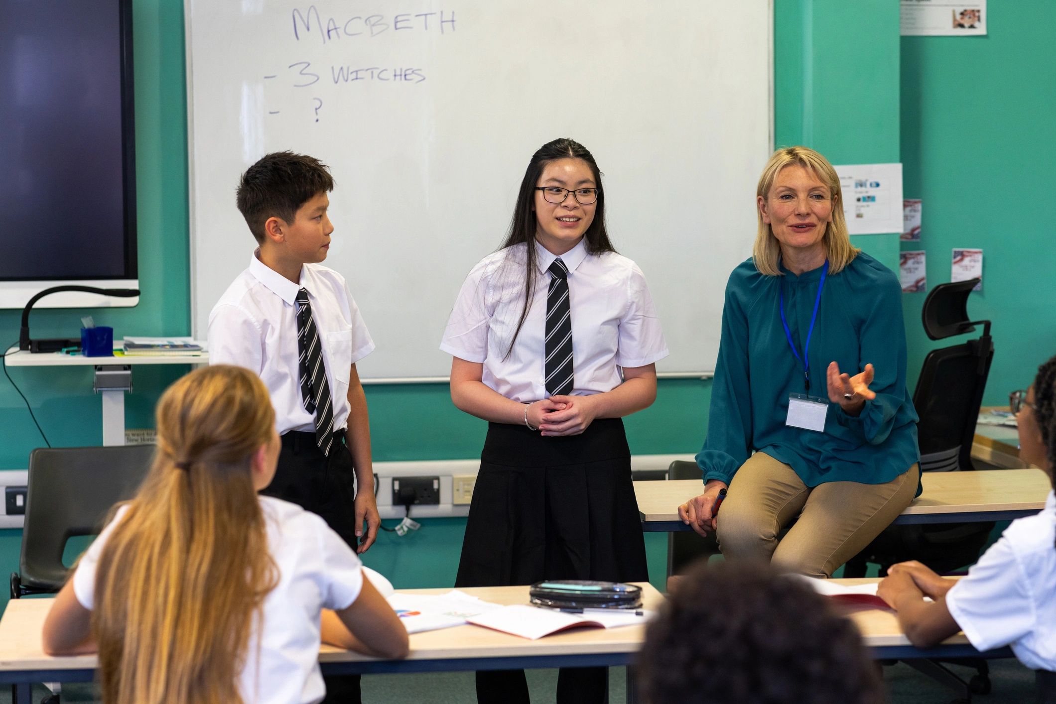 Students and teacher using classroom technology together